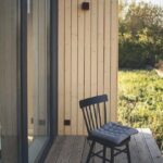 Barnhouse,_Barn_house._Wooden_secluded_house_in_the_Scandinavian_and_Finland_modern_style_with_large_windows._Exterior,_wooden_walls,_terrace,_forest_view